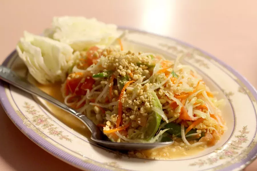 The papaya salad offers a bright, light option that doesn’t skimp on flavor. - HEATHER HOCH