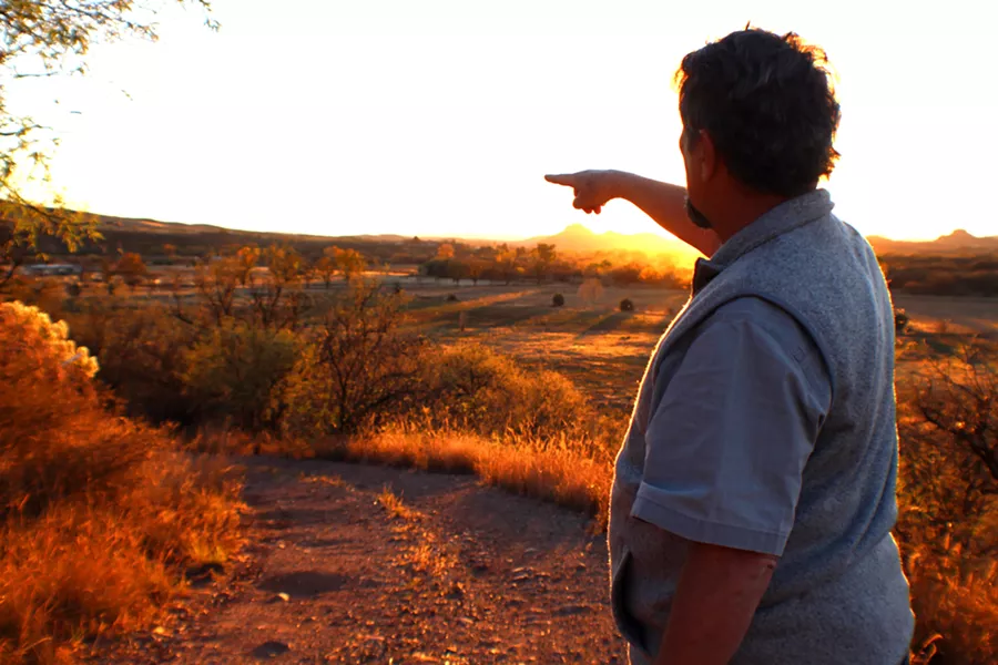 Gary Nabhan points to the Native Seeds/SEARCH Conservation Farm in the distance. - HEATHER HOCH