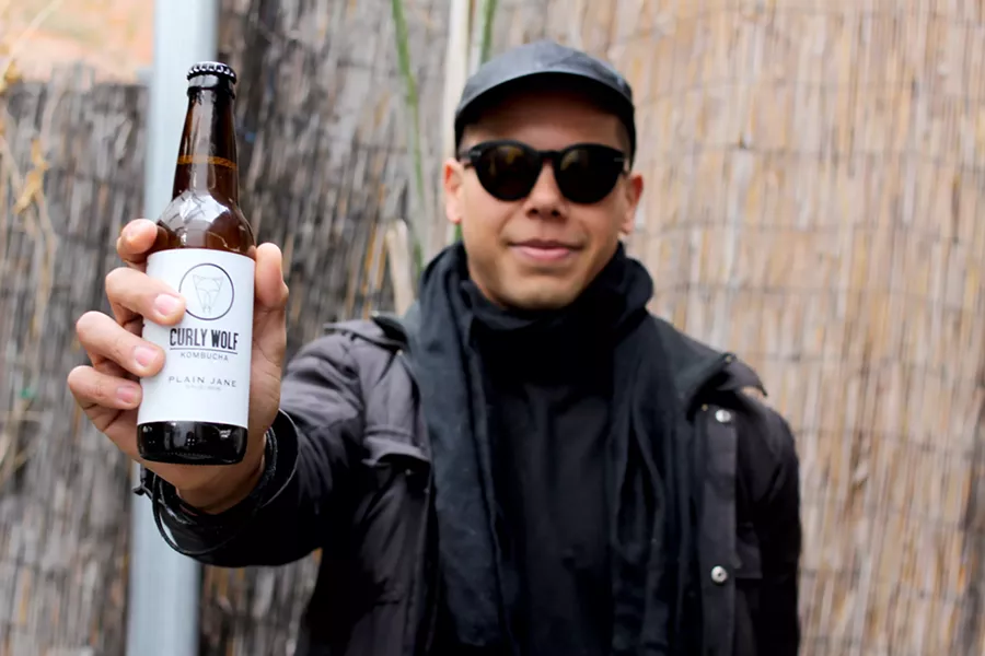 Timothy Johnson makes each bottle of Curly Wolf Kombucha by hand. - HEATHER HOCH