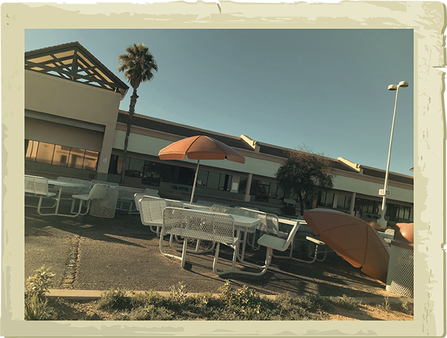 The remains of the Tanger Factory Outlet mall, now a decaying monument to highway capitalism. - COURTESY