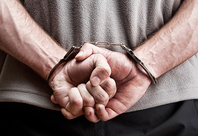 bigstock-criminal-in-handcuffs-14611325.jpg